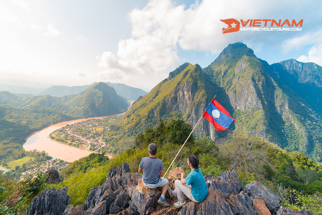 couple conquering mountain top nong khiaw panoramic view nam ou river valley laos national flag scenic mountain landscape