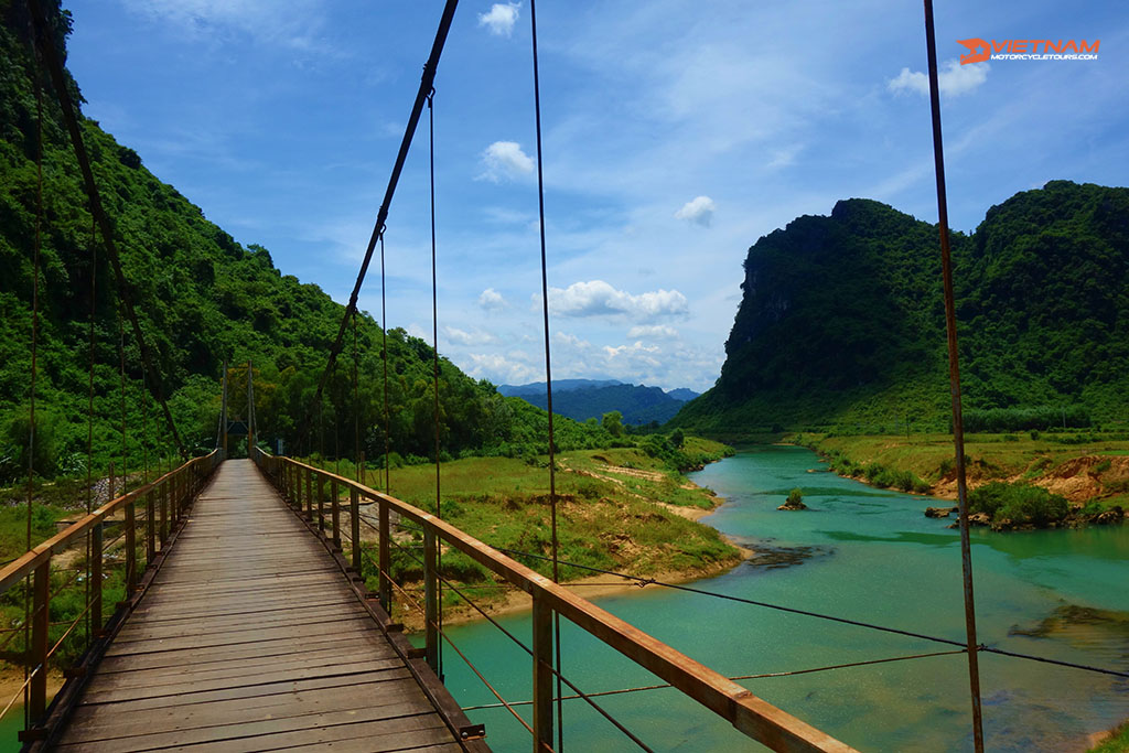 Hanging bridge with a view of green water stream in Phong Nha, Ke Bang National Park, Vietnam